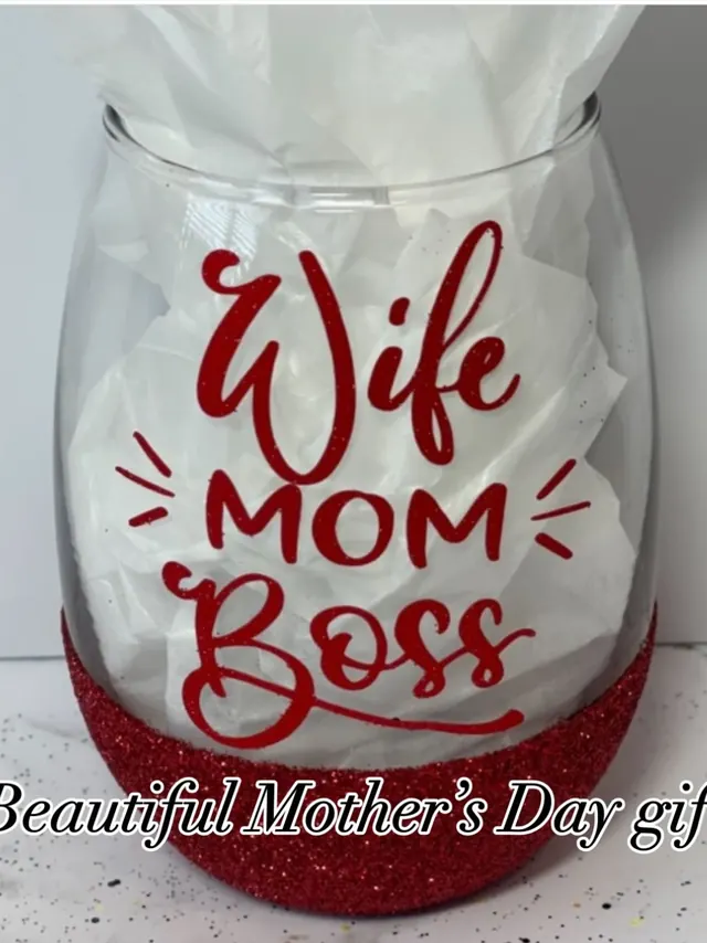 A stemless wine glass with red glitter around the base and the words Wife, Mom, Boss, made as a Mother’s Day gift.